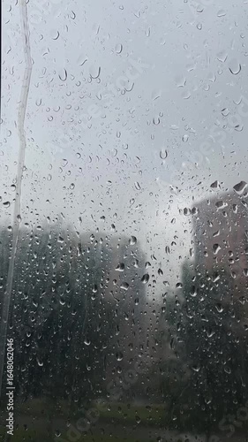 raindrops flow down the transparent surface of the umbrella