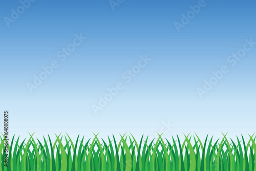 A vibrant scene showcasing green grass blades in the foreground with a simple clear blue to light blue gradient sky filling the background. The image evokes a sense of spring.