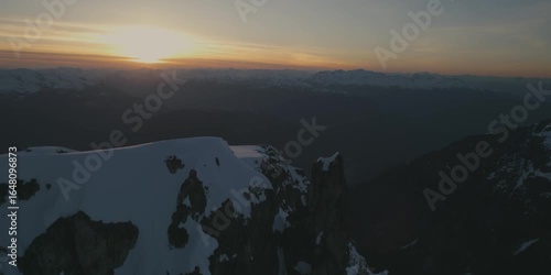 Epic aerial perspective of sunset over British Columbia Canada mountain peaks and glaciers