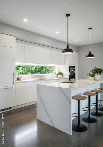 Modern, bright kitchen interior featuring a large island, sleek white cabinetry, and pendant lights.