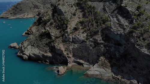 Aerial view of serene coastal bay with small boats in Spain