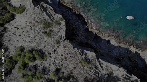 Serene boat floating near rocky shore on Costa Blanca coastline