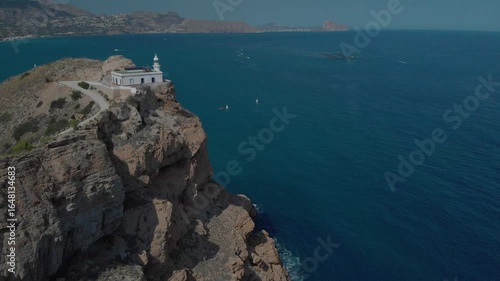 Lighthouse with solar panels on coastal cliff in Spain