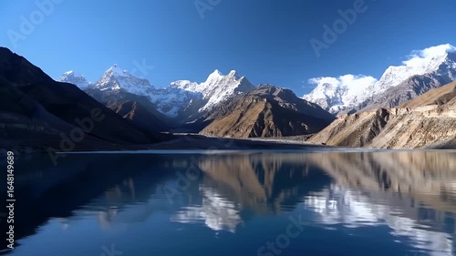 Wallpaper Mural A stunning panoramic view of snow-capped mountains reflected in a calm, clear blue lake under a bright, sunny sky. Torontodigital.ca