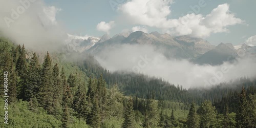 Scenic pan of beautiful Canadian Mountain Landscape with Trees and Clouds