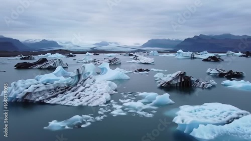 Wallpaper Mural Dramatic Aerial Flight Over a Vast Glacial Lagoon with Drifting Icebergs and Volcanic Ash. Torontodigital.ca