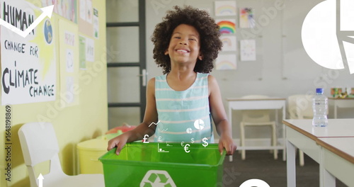 Standing child showcasing green recycling bin in school classroom, with climate awareness posters