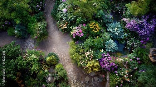 Fototapeta Naklejka Na Ścianę i Meble -  High-angle view of a vibrant, colorful garden with winding paths, filled with various flowers and plants