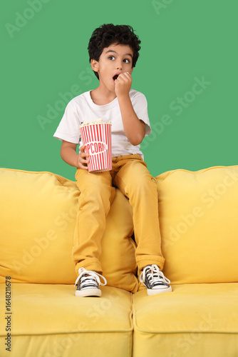Little boy with popcorn wat...