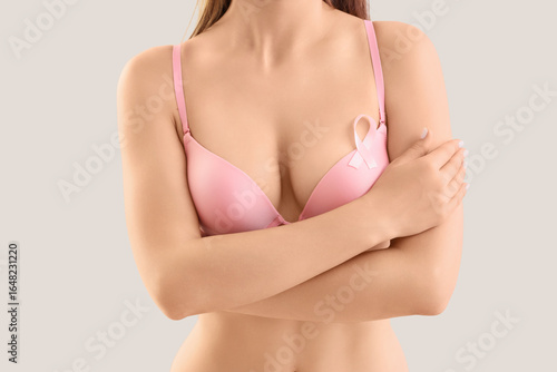 Woman in bra with pink ribb...