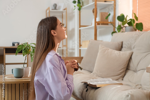Young woman praying with be...