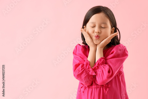 Cute little Asian girl blow...