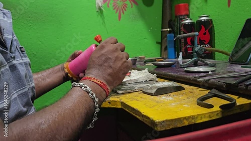 Indian Goldsmith working on his workbench. Production and making process precious gold and silver jewellery, jewells, ring jeweller, goldsmith in workshop.