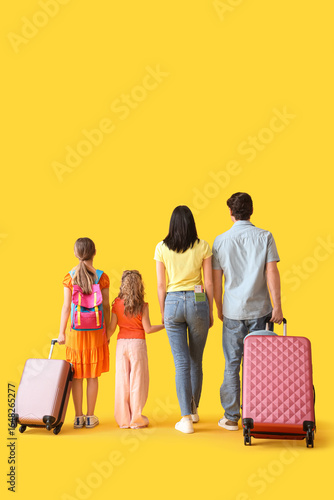 Family of tourists with sui...