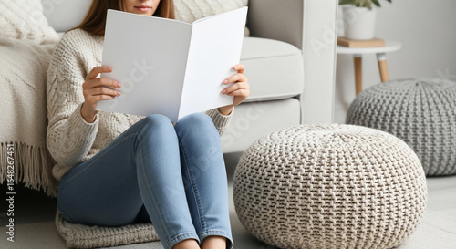 Woman Reading Blank Brochure Mockup in Cozy Home Living Room
