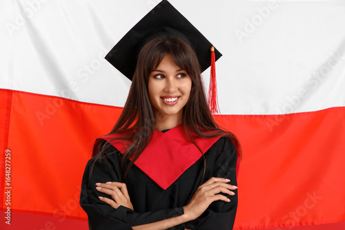 Female graduate against fla...