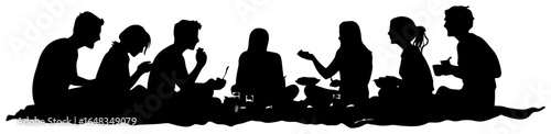 silhouette of group sitting on picnic blanket eating together