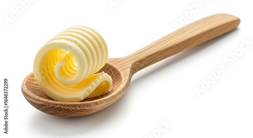 A curl of fresh yellow butter on a wooden spoon, isolated on a white background, perfect for culinary and baking themes