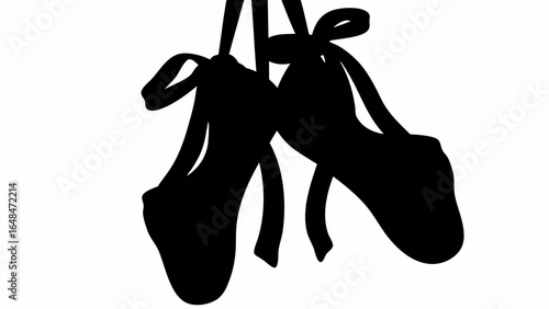 Silhouette image displaying a pair of ballet shoes hanging with ribbons, showcasing dance footwear in black