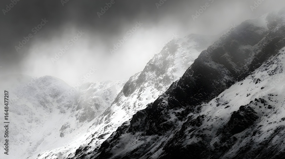 Obraz premium Snowy mountain peaks shrouded in mist.