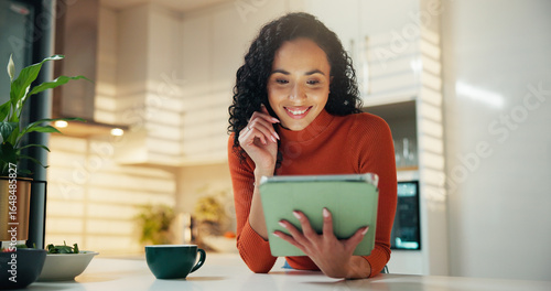 фотографія Smile, coffee and tablet with woman in kitchen for reading, social media post and news feed