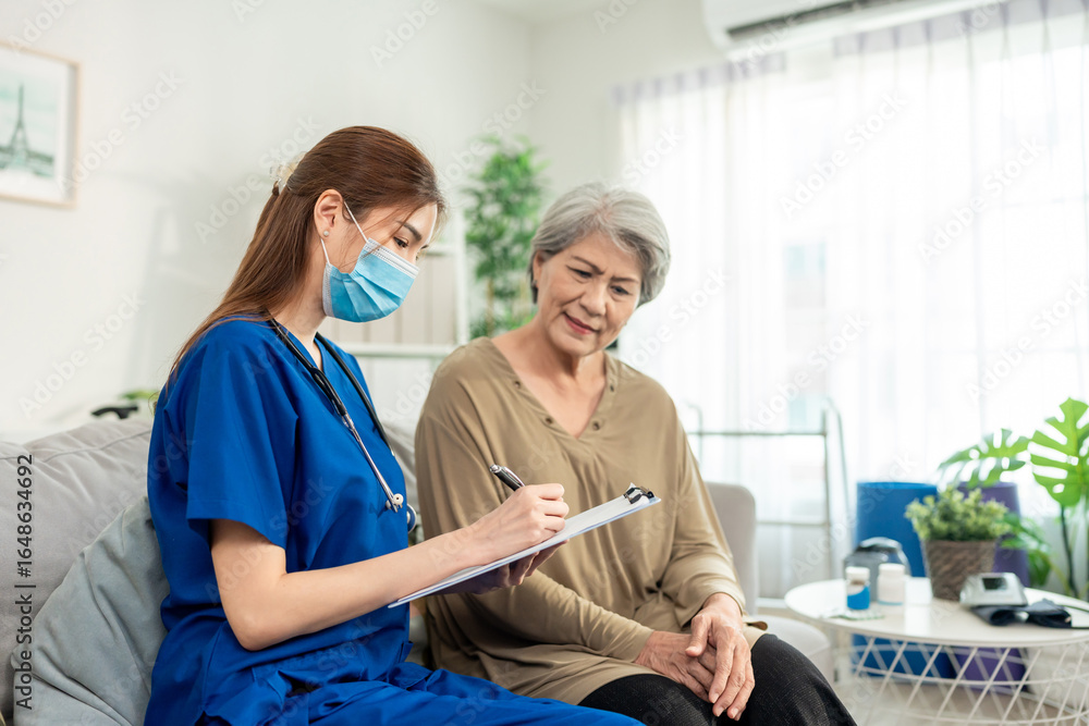 Obraz premium Asian beautiful caregiver examine senior woman patient at nursing home. 