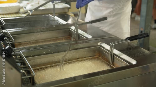 frying calamari in a restaurant fryer