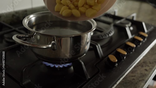 pour gnocchi into a pot of boiling water