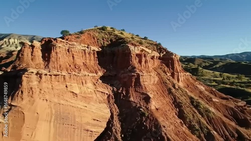 Wallpaper Mural Stunning aerial view of rugged red rock formations under a clear blue sky, surrounded by lush greenery Torontodigital.ca