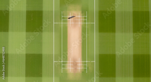 Cricket pitch with wickets and green grass from an aerial view