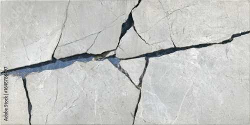 Gray stone surface with deep, irregular cracks filled with dark blue