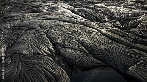 Dark, textured lava flow with a pool
