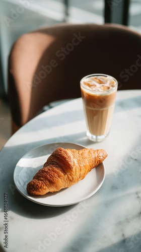 Fresh Butter Croissant with Iced Coffee on Café Table
