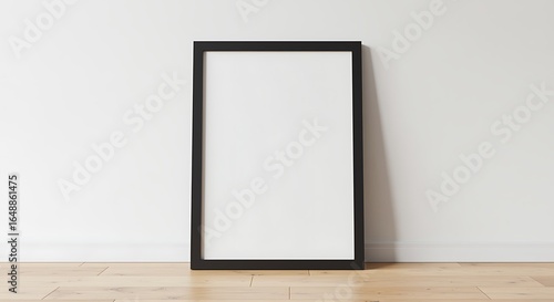 Modern Minimalist Black Frame Mockup Leaning Against White Wall on Wooden Floor for Artwork and Photography Display