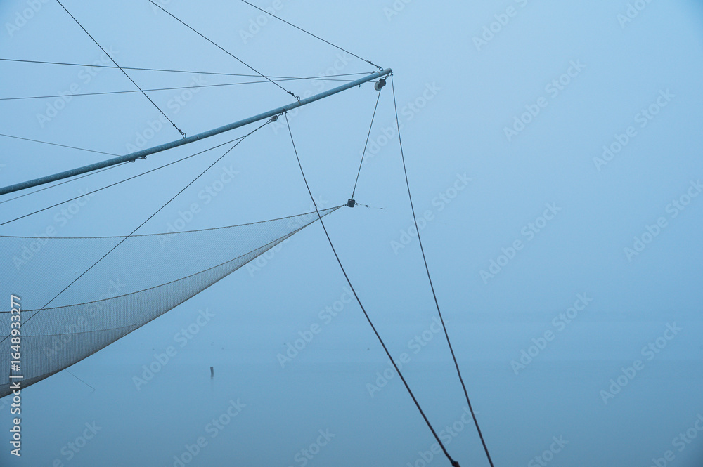 Fototapeta premium fishing net close up inside the Po river delta lagoon, Comacchio, Ferrara, Italy
