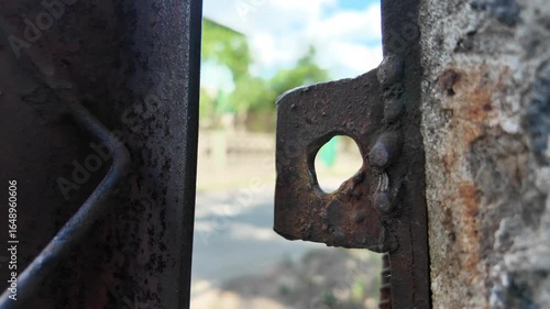 old rusty iron door. old lock. old rusty lock on the door. Rusty iron, fences of houses with debris around the beach, residential areas that were flooded