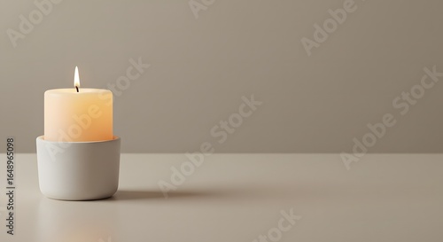 Wallpaper Mural A lit ivory candle rests in a minimalist white holder on a pale surface, creating a serene and calming atmosphere. Torontodigital.ca