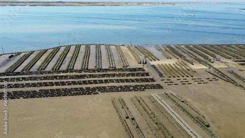 Ria Formosa riverbed with shellfish production and yachts anchored in the river