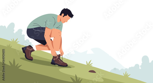 Man Tying His Hiking Boots On The Hillside Before Setting Off