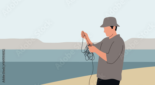 Man Unraveling Fishing Line At The Seaside Preparing For Angling Activity