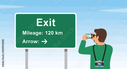 Photographer Capturing Roadside Exit Sign During Scenic Travel Route Experience