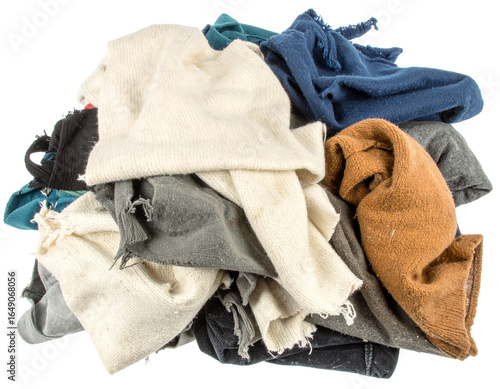 A pile of dirty, discarded clothing and rags, isolated on a white background, symbolizing textile waste and the need for recycling.