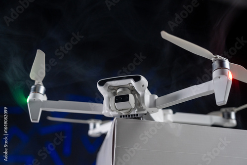 White Flying Drone with Camera on black background 