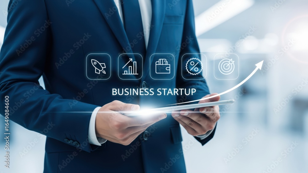 Obraz premium Man in blue suit holding tablet with glowing icons of business startup and arrow rising upward to show progress and success in startup
