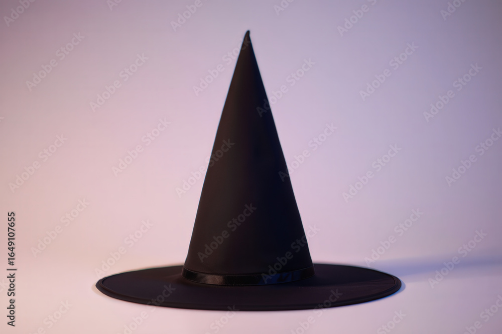 Fototapeta premium A classic black pointed hat, perfect for Halloween celebrations and spooky themed events, embodying the spirit of magic.