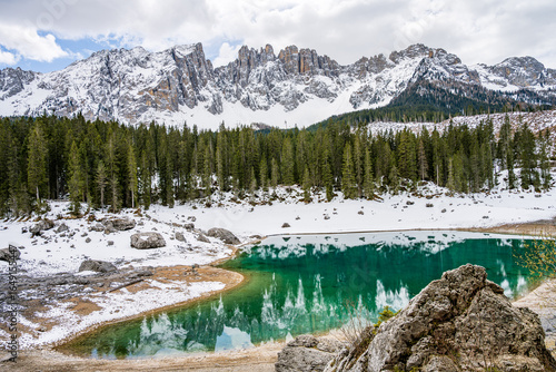 Lake Carezza or Karersee , wide angle view of scenic landscape in Italy. Dolomites mountains on background, Italian Alps. Nature and travel concepts
