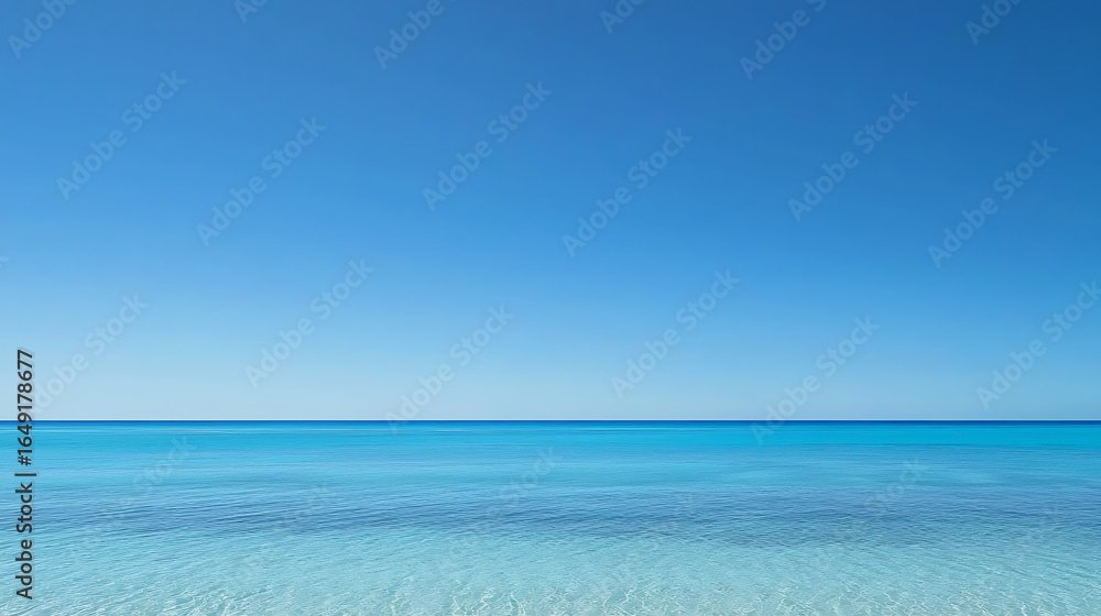 Obraz premium The ocean is calm and clear, with a bright blue sky above