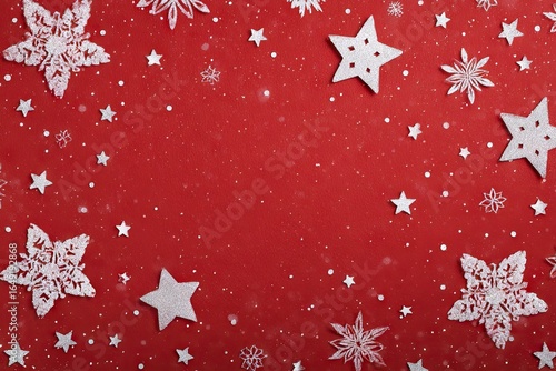 Festive, flat lay design with white paper snowflakes and stars on a red background