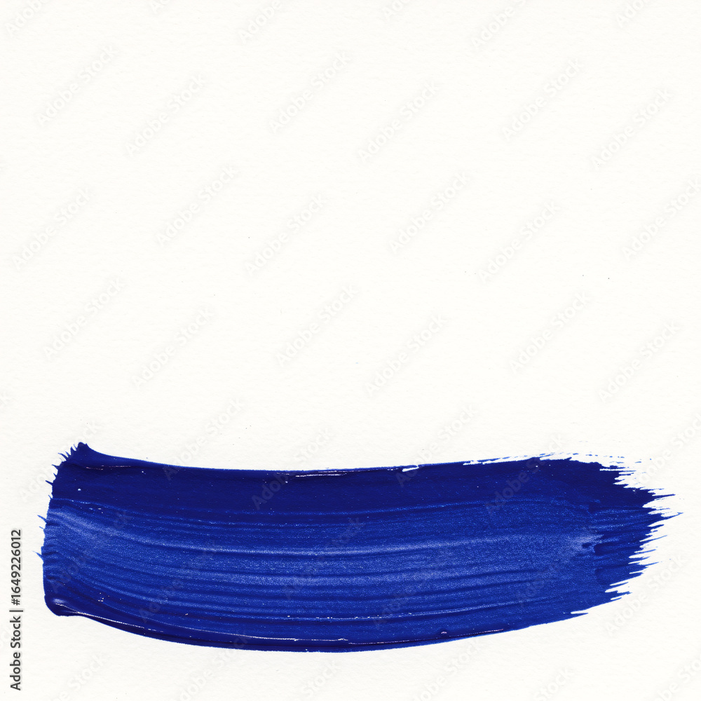 Fototapeta premium Minimalist abstract background of a single bold blue acrylic paint brushstroke on white paper. A textured design element, underline, or title swipe with ample vertical copy space for text and graphics