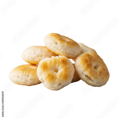 Small, artfully piled beige oyster crackers, puffy, airy, with flaky imperfections, isolated on transparent background with soft bokeh, studio food product concept